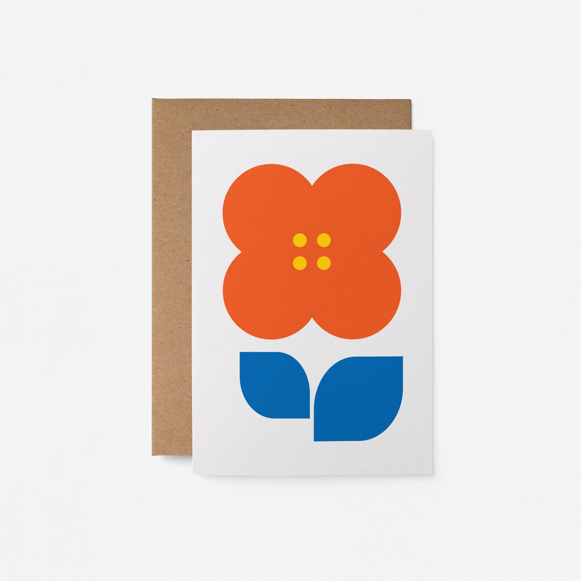 Flower greeting card showcasing a bold red flower with blue and green accents on a white background, paired with a kraft envelope.