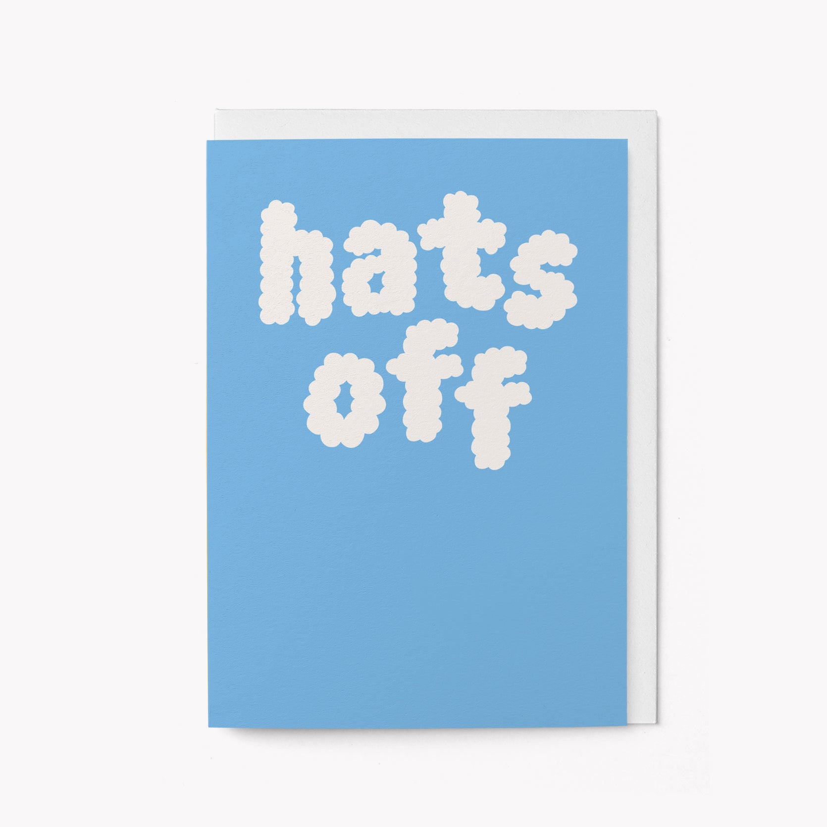 Graduation card with 'hats off' text on a blue background and white envelope