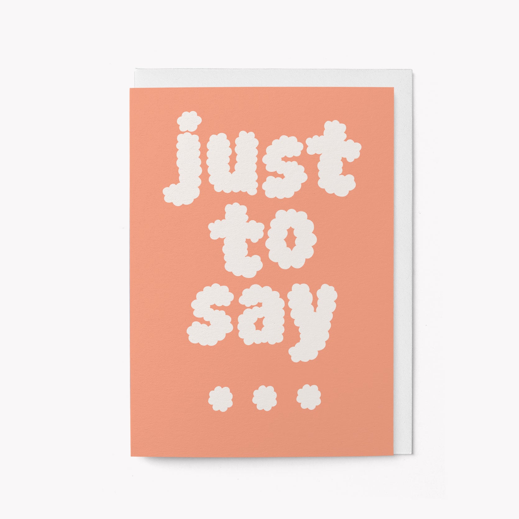 Greeting card with 'just to say' text on a coral background