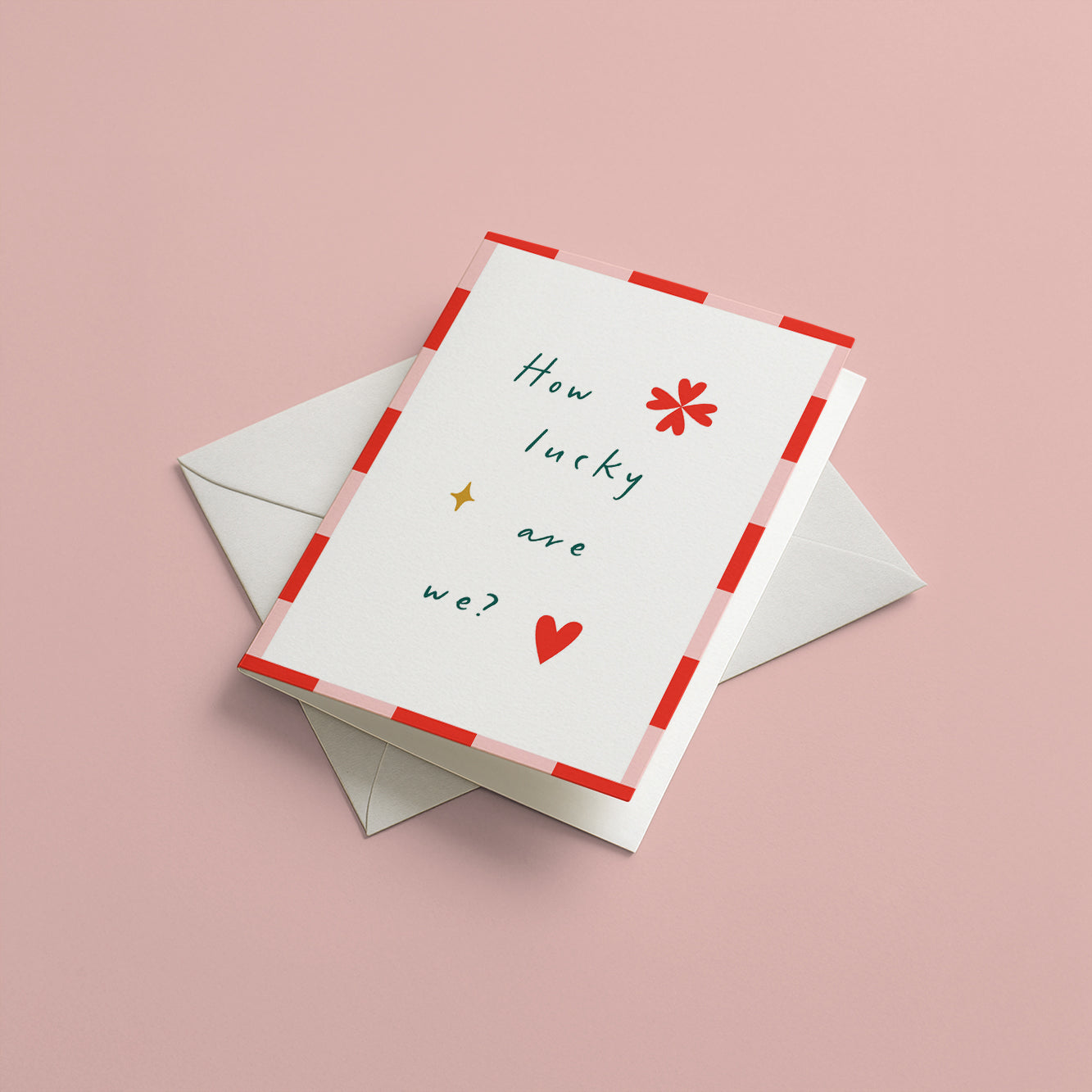 Greeting card with 'How lucky are we?' text and a heart on a pink background