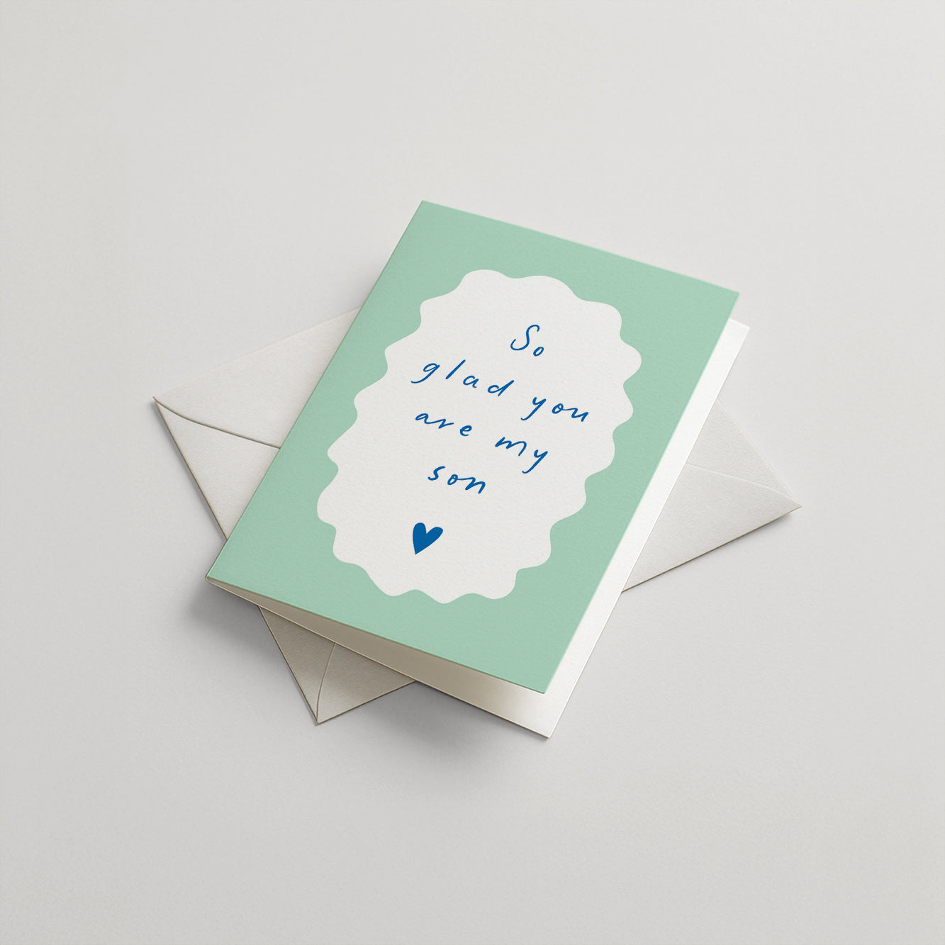 Greeting card with 'So glad you are my son' text on a light green background
