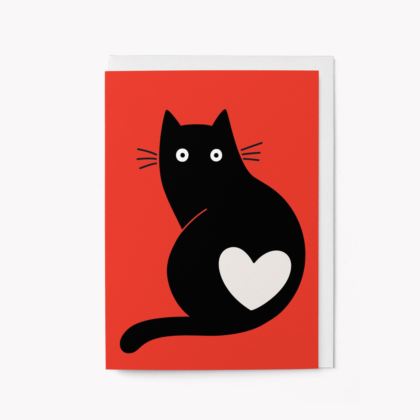 Greeting card of a black cat with a white heart on a red background