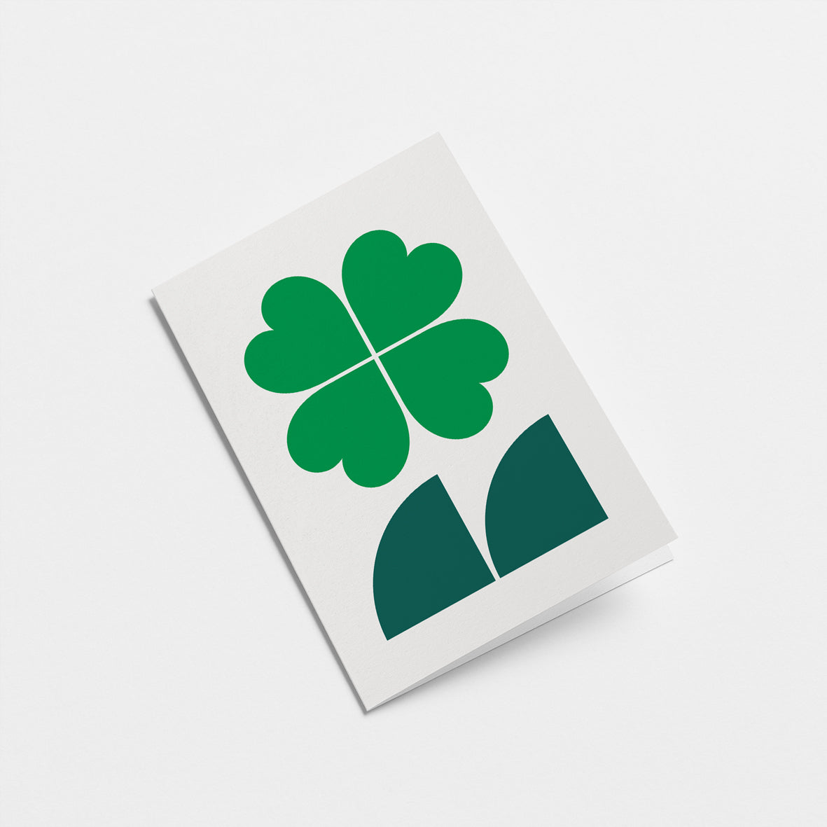everyday greeting card with four leaf clover and dark green leafs