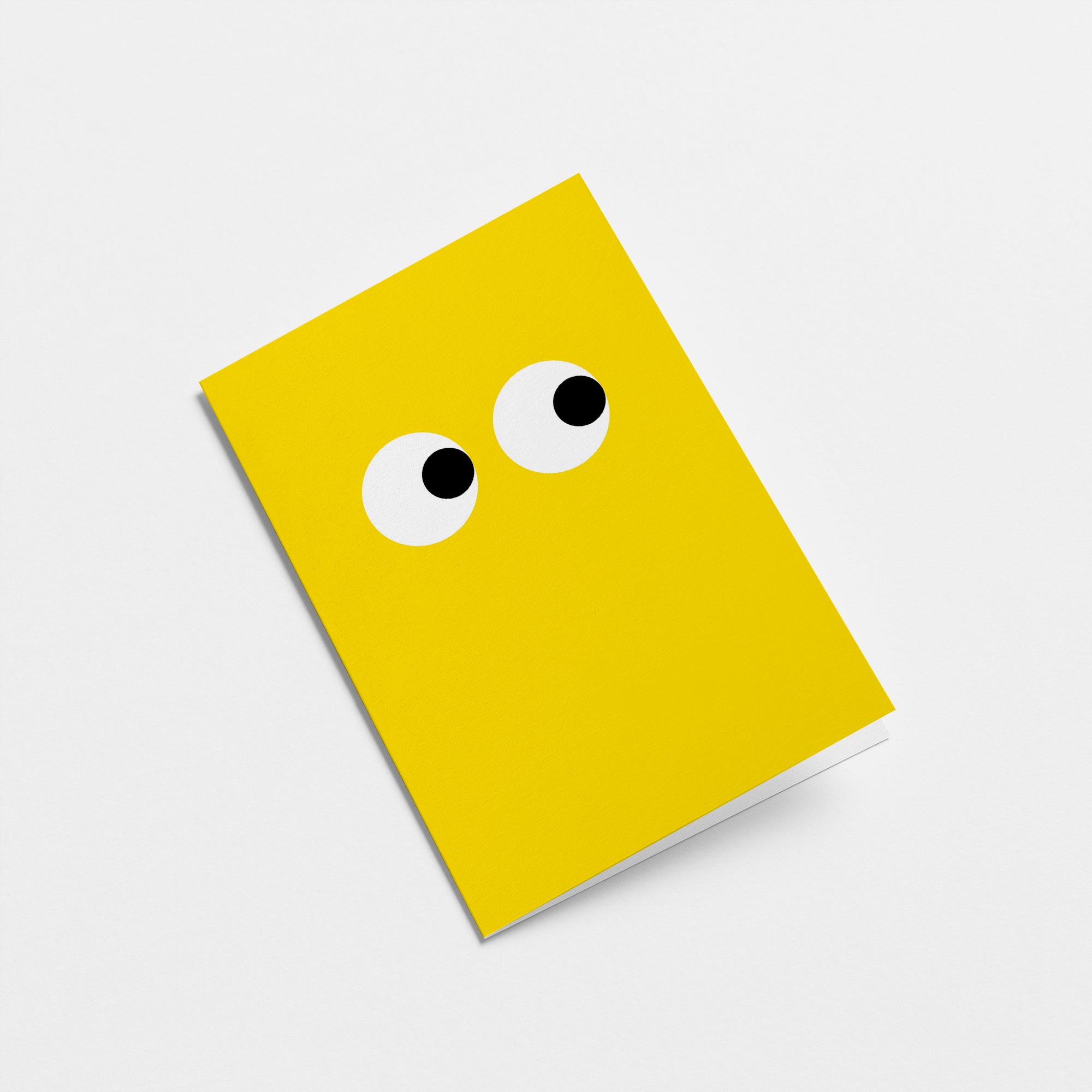 yellow greeting card with side-eyeing eyes Edit alt text