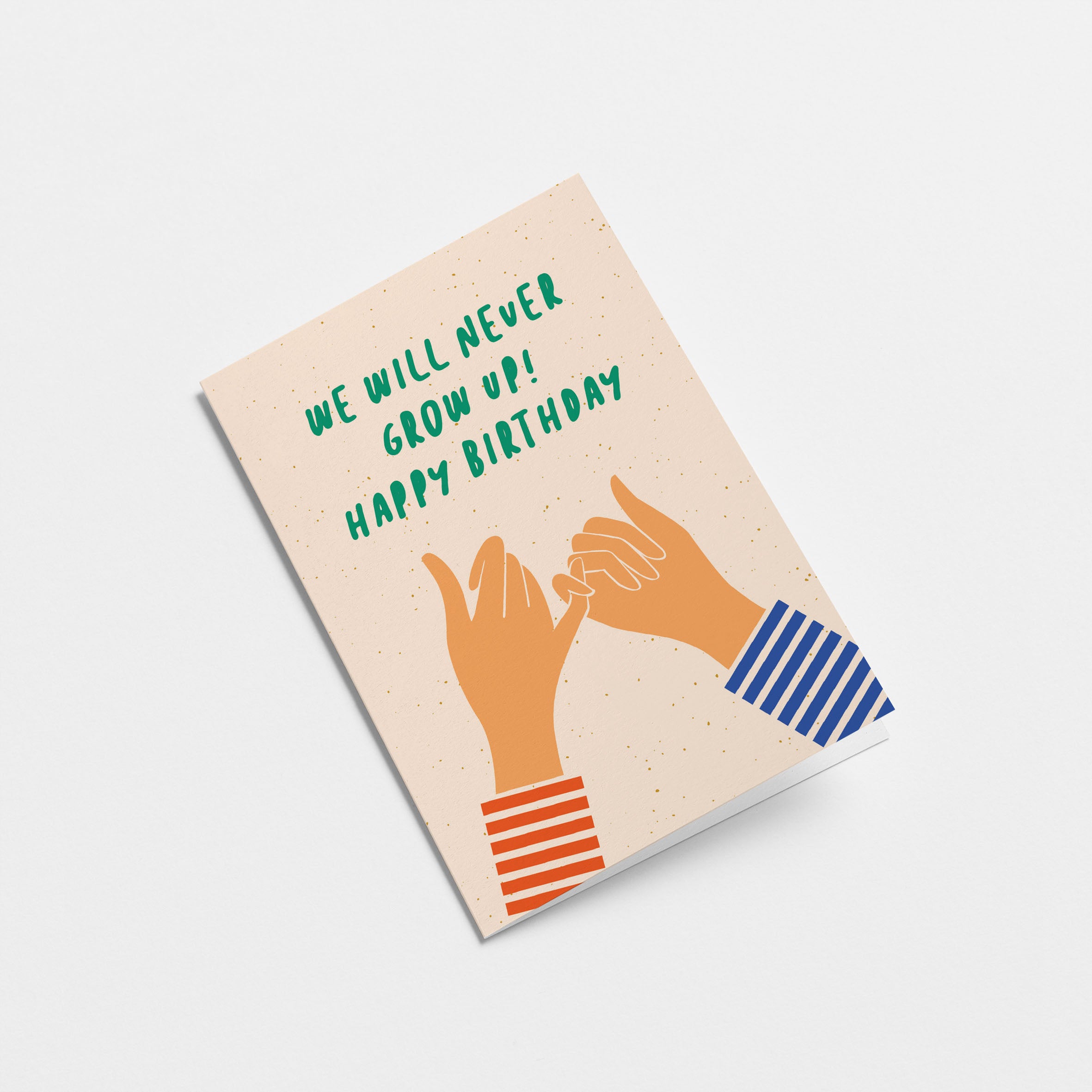 Birthday card with two hands creating gesture of promise with little fingers and a text that says we will never grow up happy birthday Edit alt text