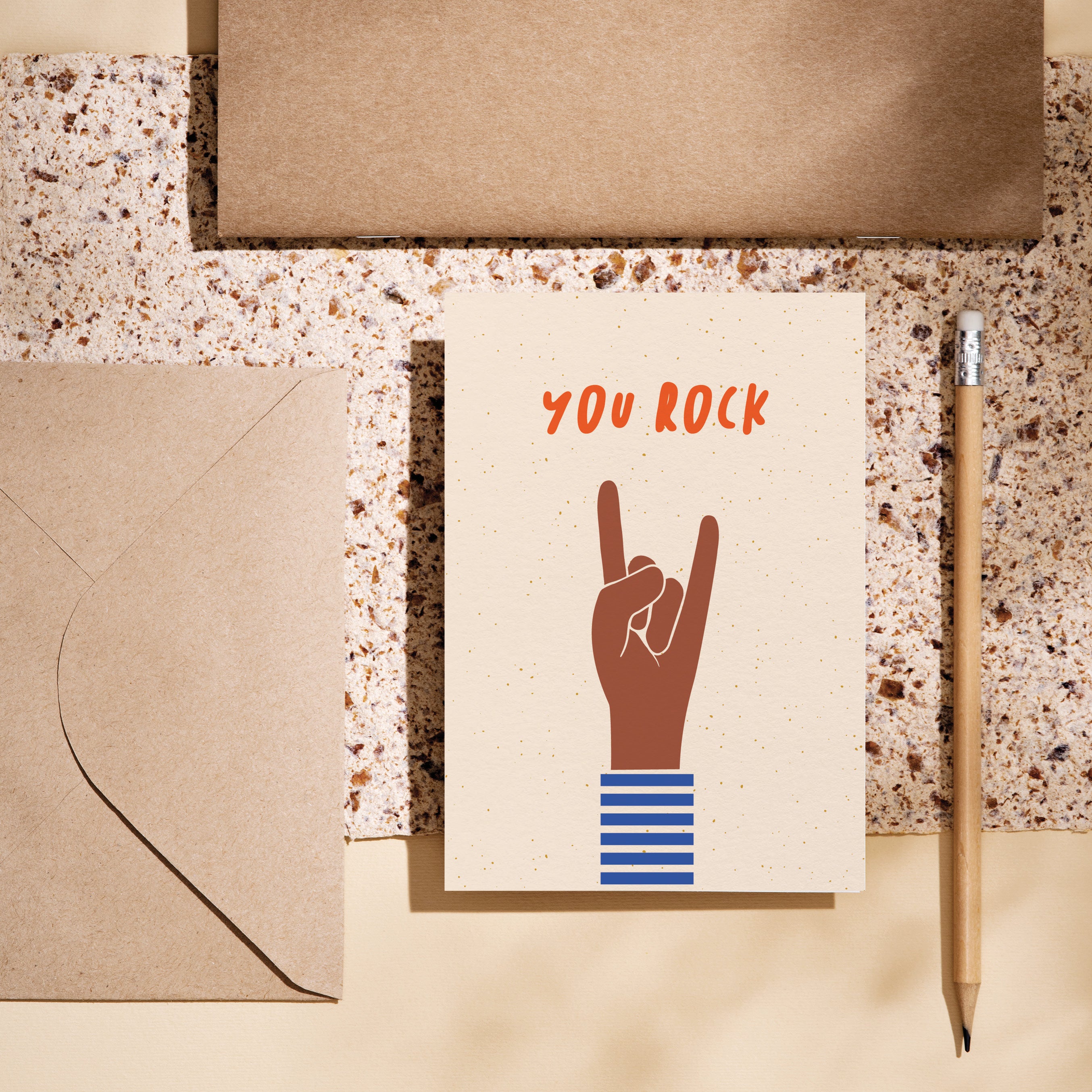 birthday card with a brown hand and a gesture of sign of the horns with a text that says you rock Edit alt text