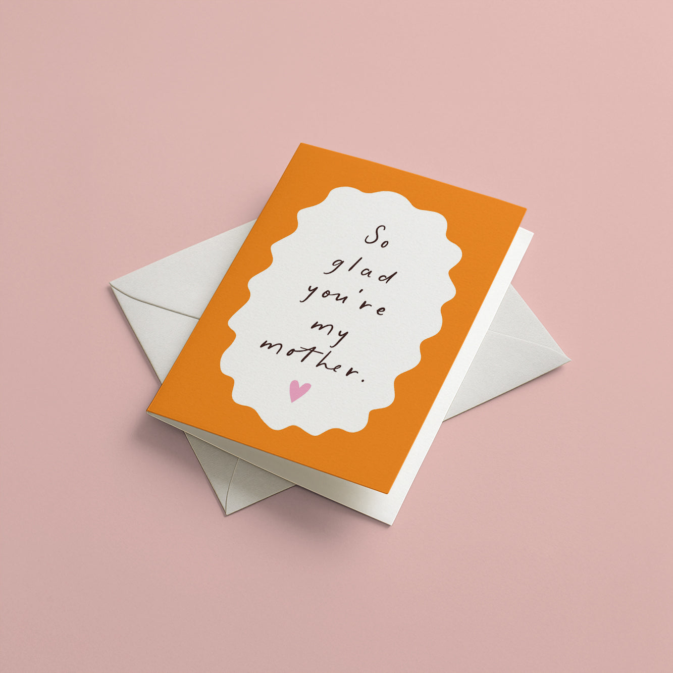 Greeting card with 'So glad you're my mother' text on an orange background, with a white envelope.