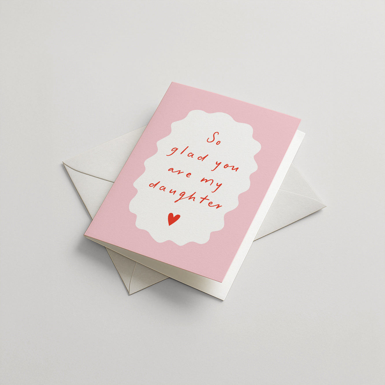 Greeting card with 'So glad you are my daughter' text on a pink background, with an envelope.