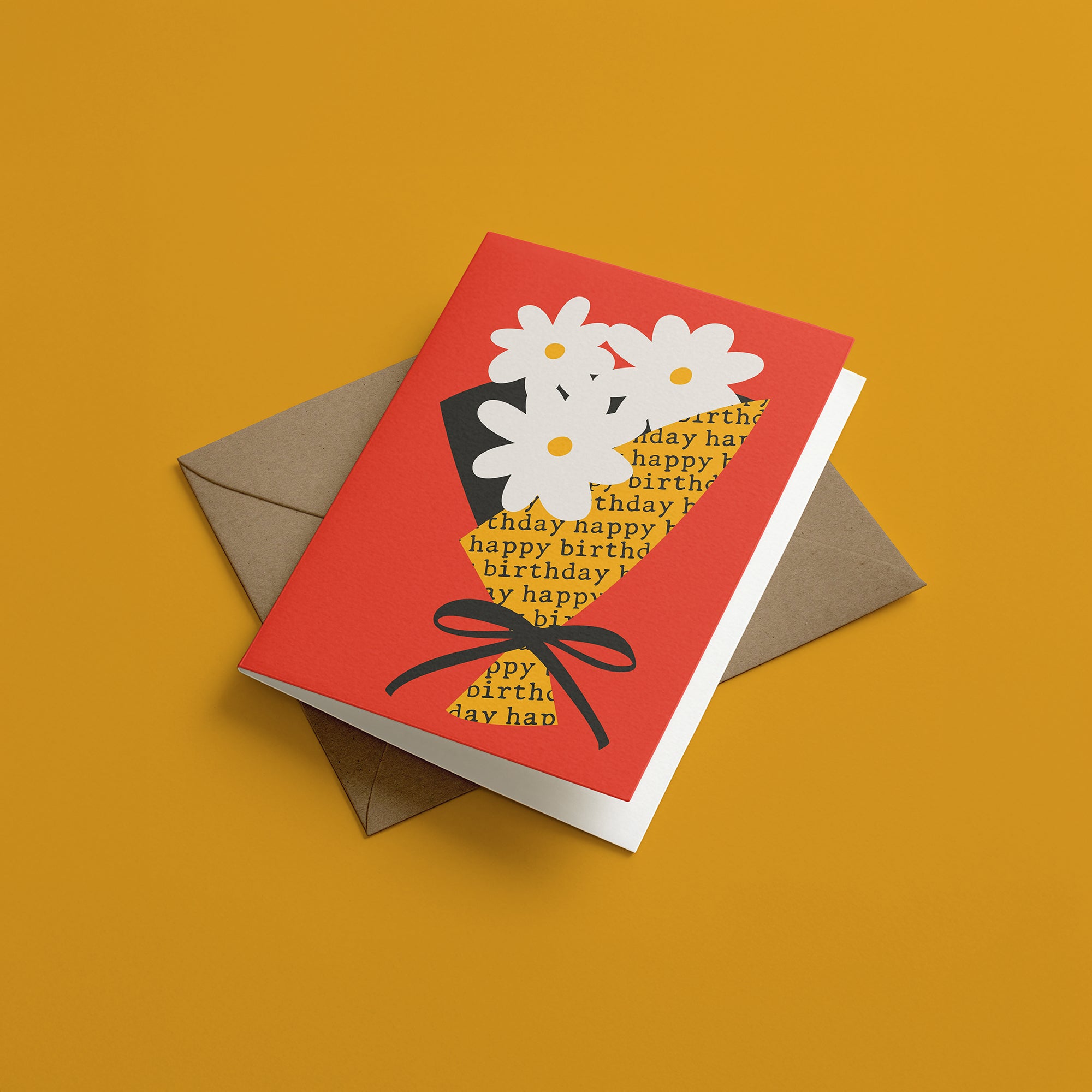 Red birthday card with white flowers and a kraft envelope on an orange background