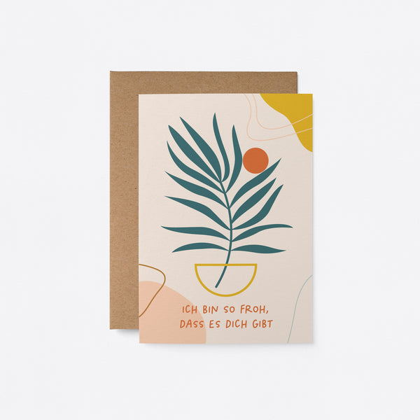 German birthday card with a green plant drawing and a orange sun figure and a text that says Ich bin so froh, dass es dich gibt