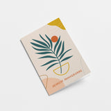 French birthday card with a green plant drawing and a orange sun figure and a text that says Heureux anniversaire