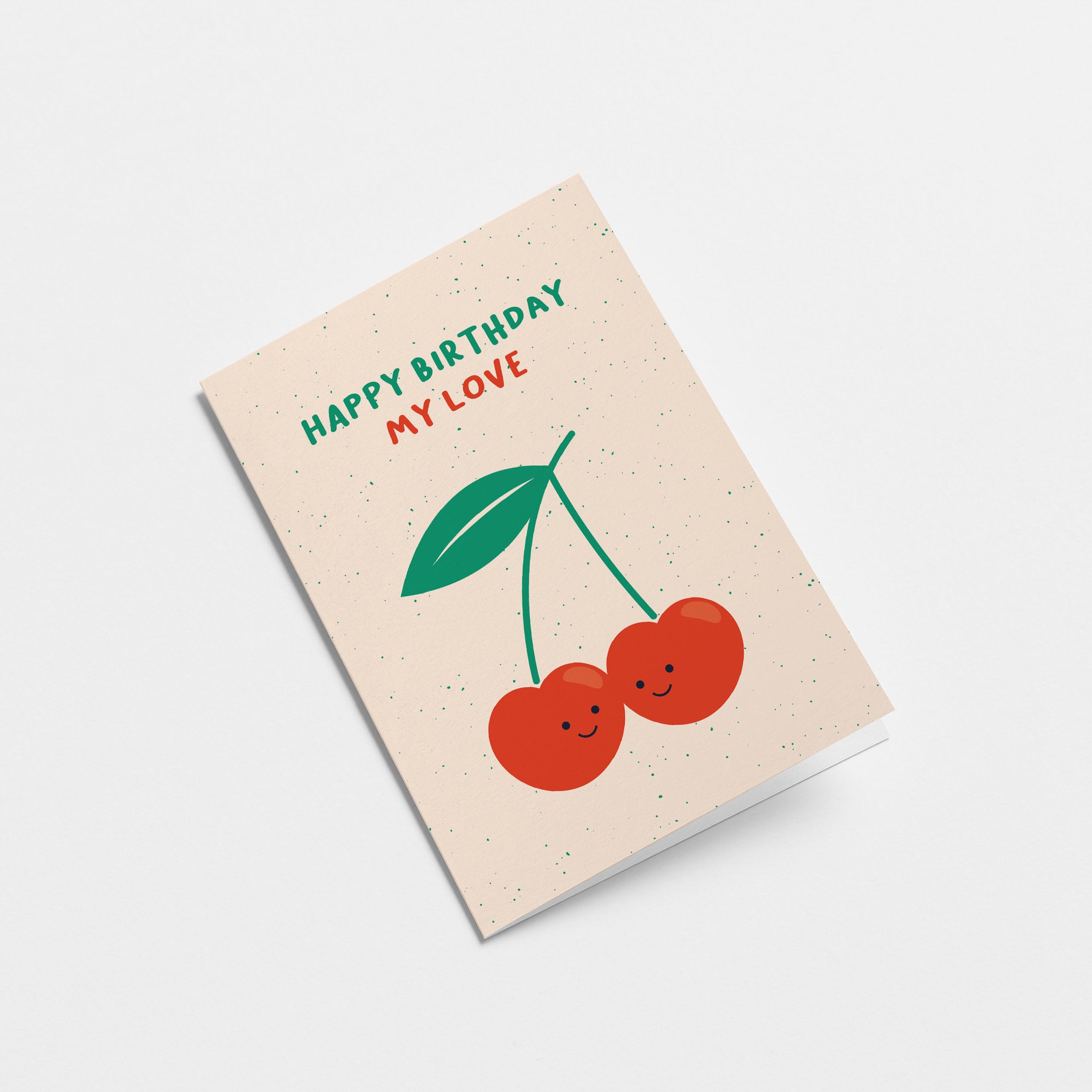 Birthday greeting card with two red cherries touching each other and a text that says happy birthday my love