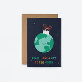 christmas card with a earth shaped christmas tree decoration and a text that says peace love and joy to the world