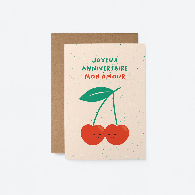 French Birthday greeting card with two red cherries touching each other and a text that says Joyeux anniversaire mon amour