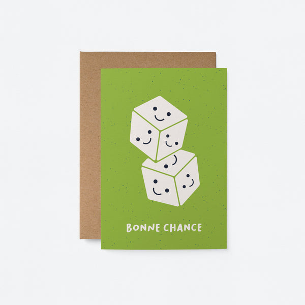 French Good Luck card with two white dices on top of each other with smiley faces in each face and a text that says Bonne chance