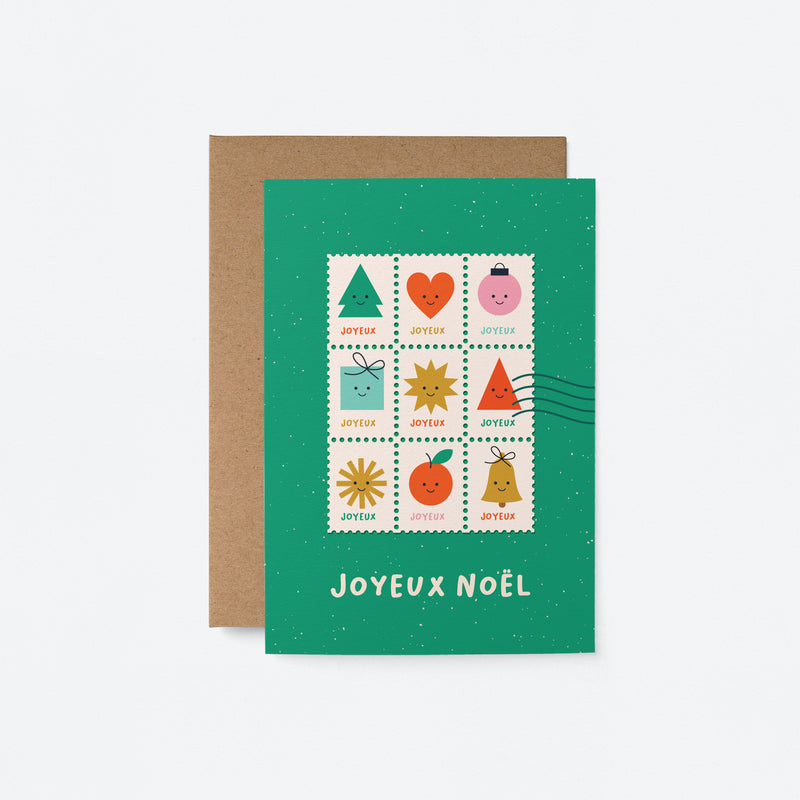 French christmas greeting card with colorful letter stamps on a green card and a text that says Joyeux Noël
