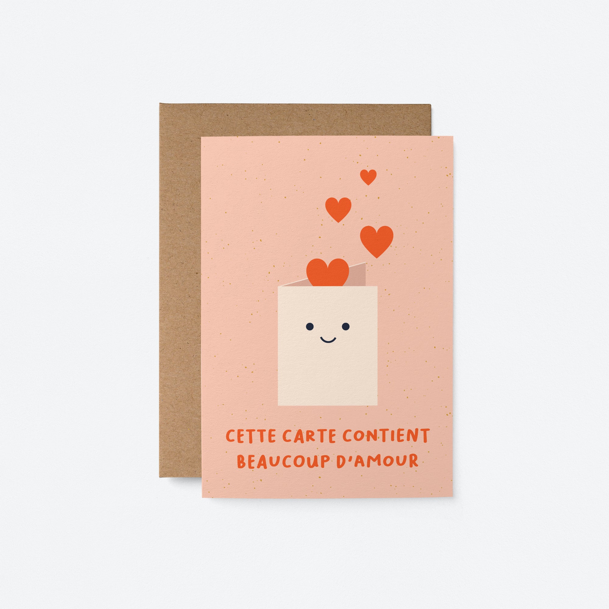 French friendship card with a white envelope and red heart shapes and a text that says Cette carte contient beaucoup d’amour