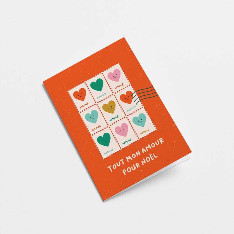 French christmas greeting card with colorful heart shaped letter stamps and a text that says Tout mon amour pour Noël  Edit alt text