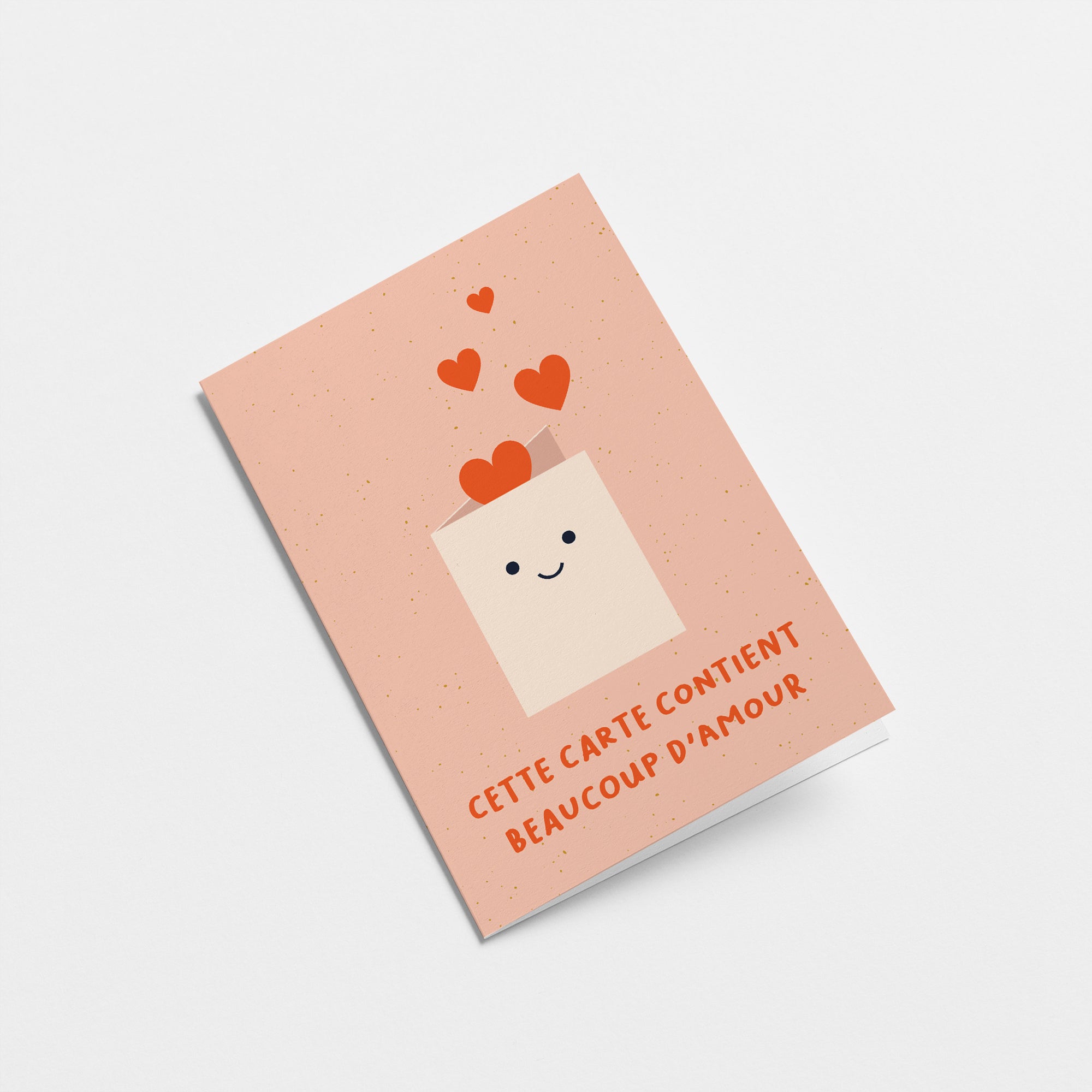 French friendship card with a white envelope and red heart shapes and a text that says Cette carte contient beaucoup d’amour  Edit alt text