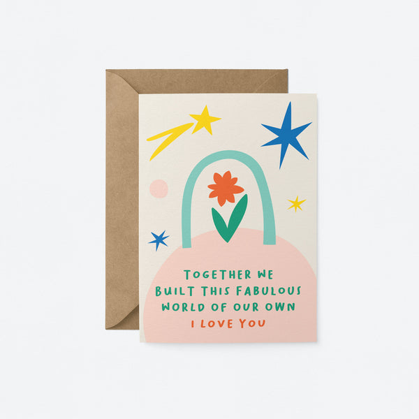 Love card with red and green flower, blue, yellow and pink figures with a text that says together we built this fabulous worlf of our own i love you  Edit alt text