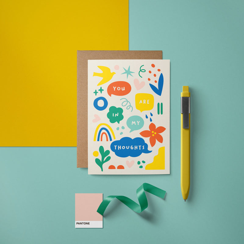Greeting card with yellow, red, blue, green, pink figures and a text that says You are in my thoughts  Edit alt text