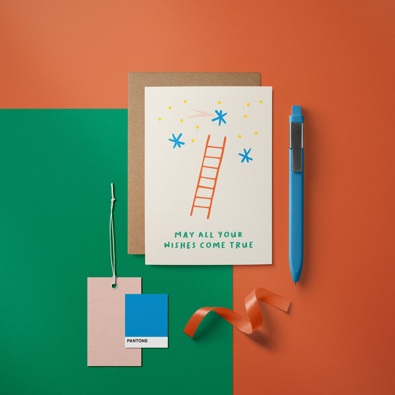 Birthday card with a red ladder and blue stars and a text that says May all your wishes come true  Edit alt text