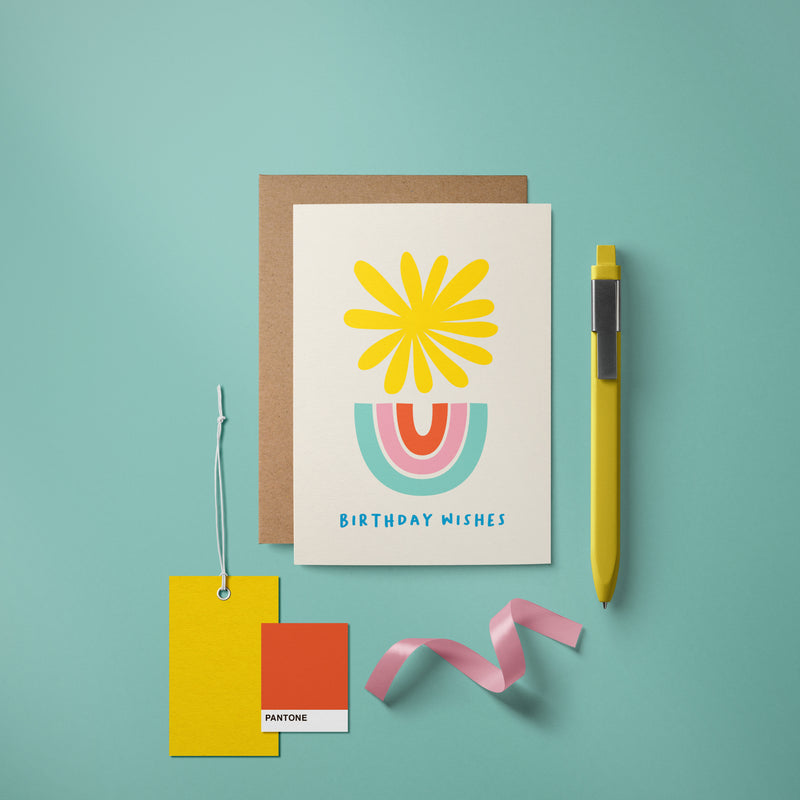 Birthday card with a yellow sun and blue, pink, red rainbow and a text that says Birthday Wishes  Edit alt text
