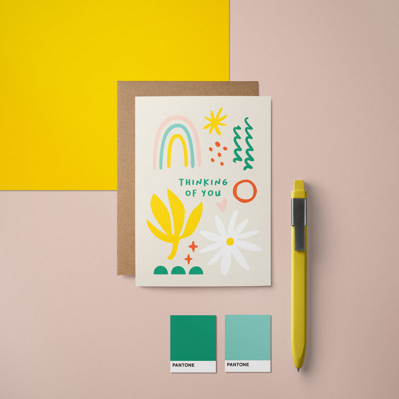 Sympathy card with rainbow, white flower, yellow plant, green, red and yellow figures with a text that says thinking of you  Edit alt text