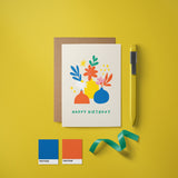 Birthday card with red,blue,yellow,green flowers in red,yellow,blue flowerpots with a text that says happy birthday  Edit alt text