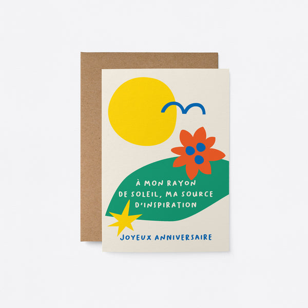 French Birthday card with yellow sun, blue bird, green, red, blue figures and a text that says À mon rayon de soleil, ma source d’inspiration. Joyeux anniversaire