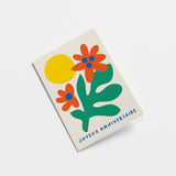 French Birthday card with green plant, red and blue flowers and yellow sun with a text that says Joyeux anniversaire  Edit alt text