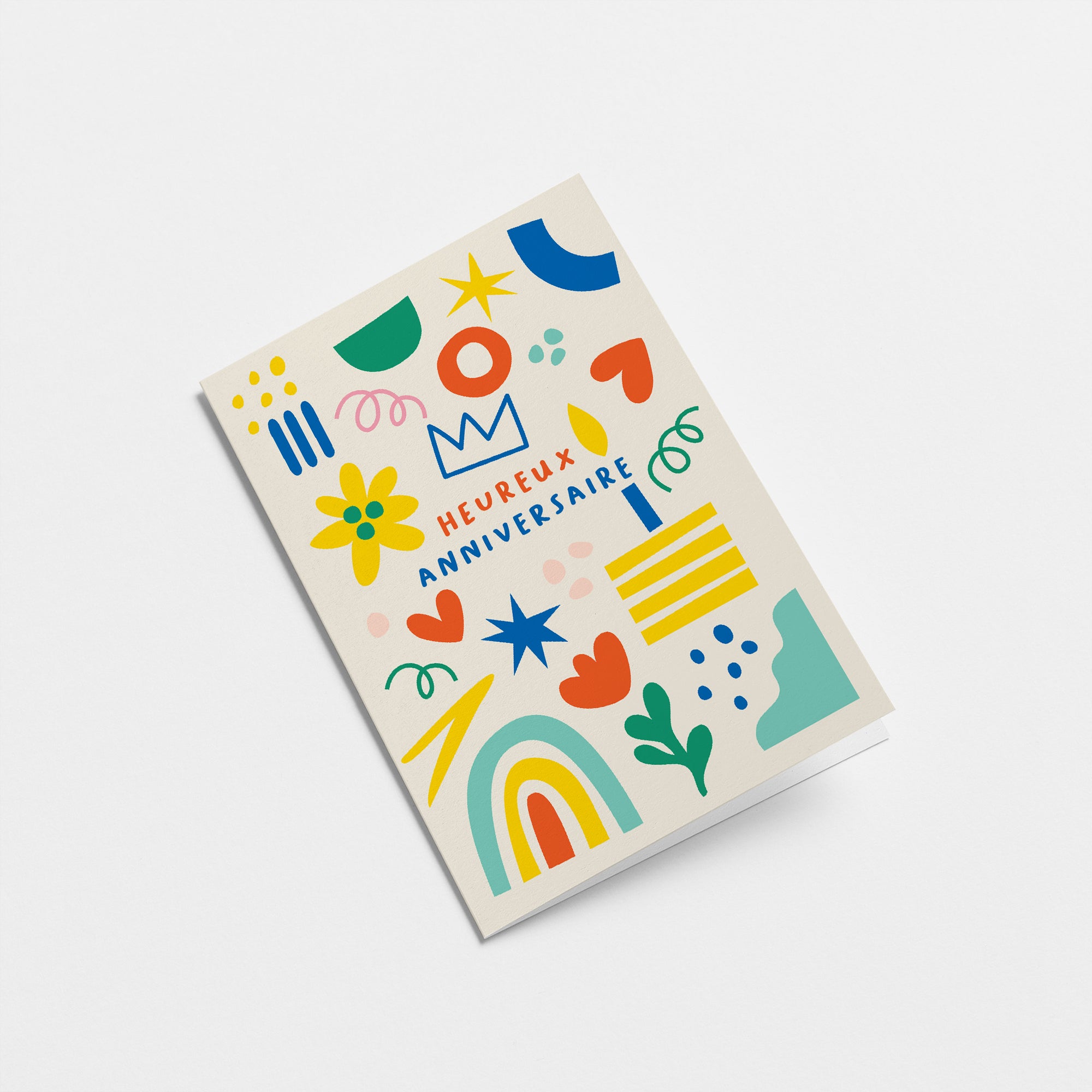 French Birthday card with green, red, yellow, blue figures and a text that says Heureux anniversaire  Edit alt text