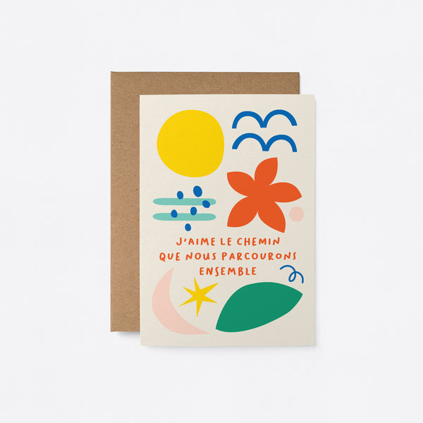 French Love card with yellow sun, blue birds, red flower, green, pink, blue and yellow figures and a text that says J’aime le chemin que nous parcourons ensemble