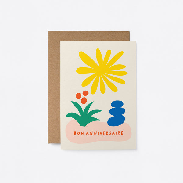 French Friendship card with yellow sun figure, green and red flower, blue figure and a text that says Bon anniversaire