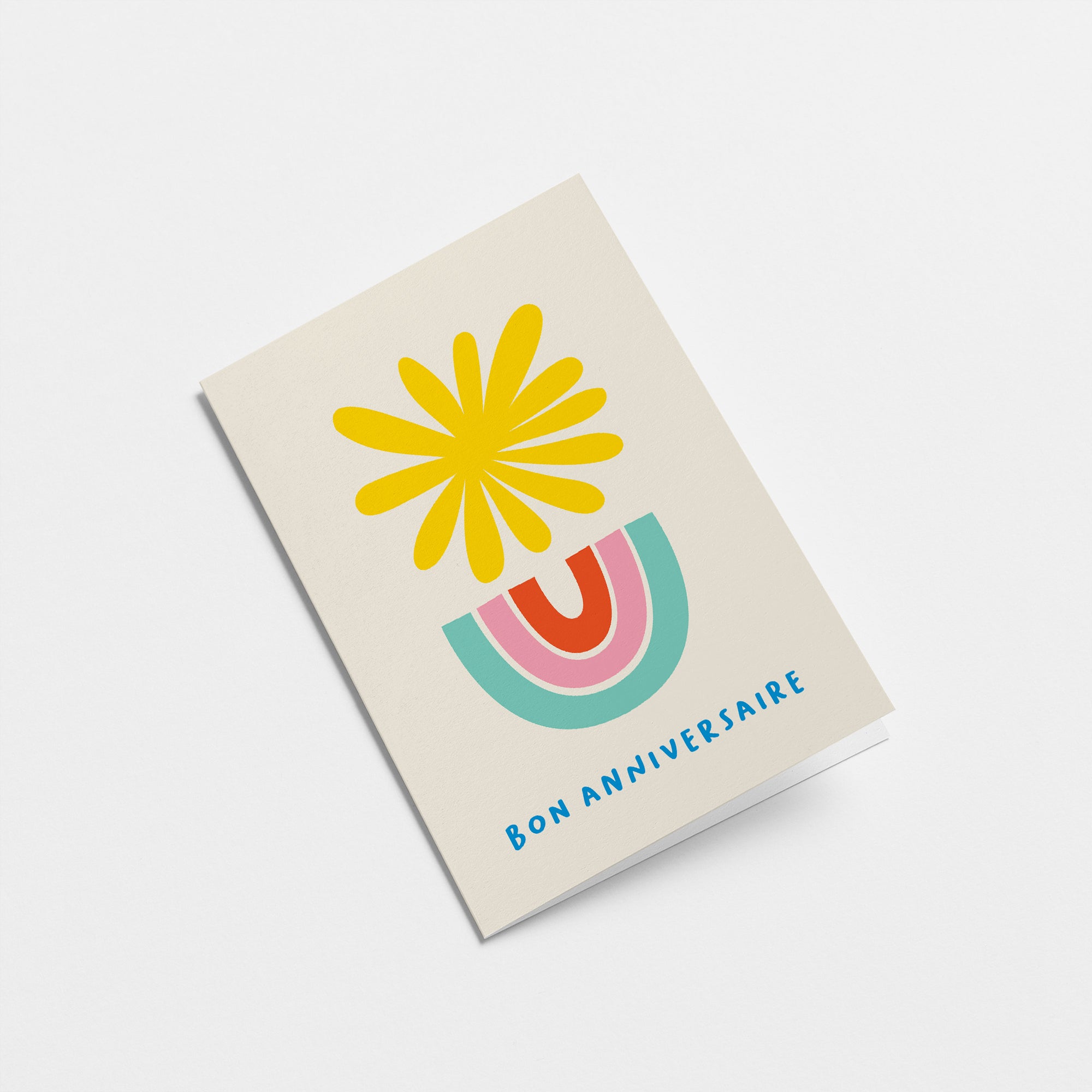 French Birthday card with a yellow sun and blue, pink, red rainbow and a text that says Bon anniversaire  Edit alt text