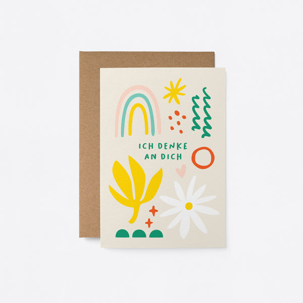 German Sympathy card with rainbow, white flower, yellow plant, green, red and yellow figures with a text that says Ich denke an dich