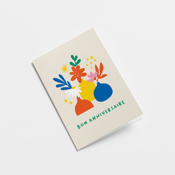French Birthday card with red,blue,yellow,green flowers in red,yellow,blue flowerpots with a text that says Bon anniversaire  Edit alt text