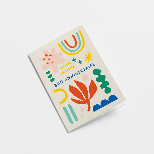 French Birthday card with rainbow, red flower, pink,red,yellow,green,blue figures and a text that says Bon anniversaire  Edit alt text