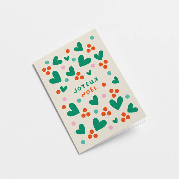 French Christmas card with green heart shapes, red dots and a text that says Joyeux et lumineux  Edit alt text