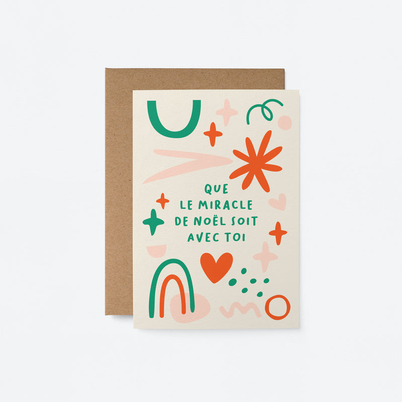 French Christmas card with red, green, pink figures with a text that says Que le miracle de Noël soit avec toi