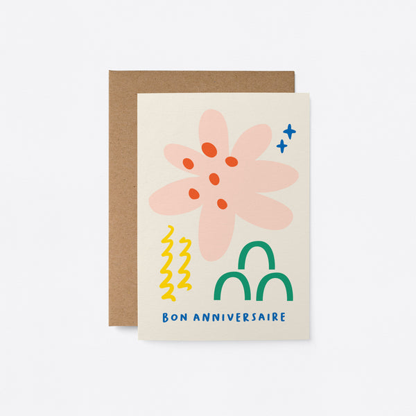 French birthday card with pink, red, yellow, green and blue figures and a text that says Bon anniversaire