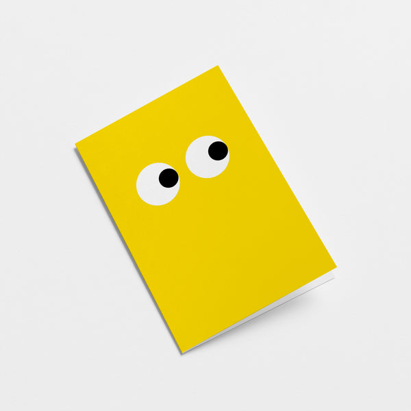 yellow greeting card with side-eyeing eyes  Edit alt text