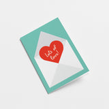 love card with a red heart shape in a white envelope with a text that says lots of love  Edit alt text