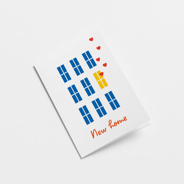 housewarming card with blue windows and yellow windows with floating red hearts with a text that says new home  Edit alt text
