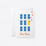 housewarming card with blue windows and yellow windows with floating red hearts with a text that says new home