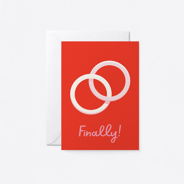 wedding card with two white rings one within the other and a text that says finally