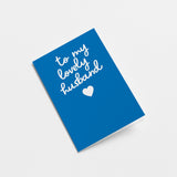 everyday greeting card with blue background and a white heart with a text that says to my lovely husband  Edit alt text