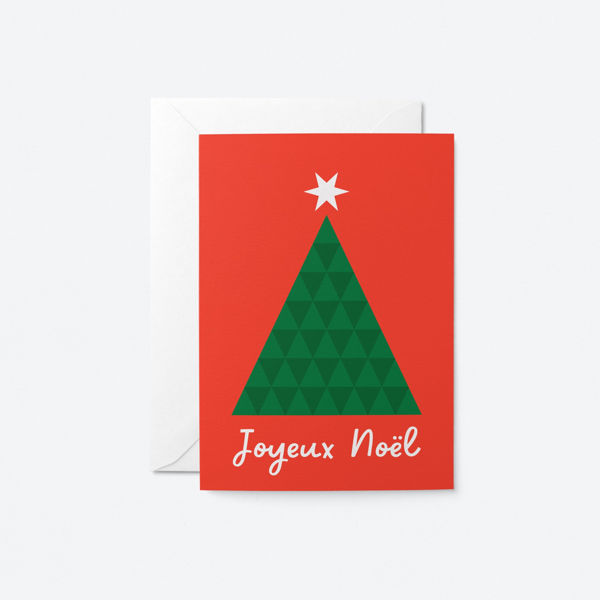 french christmas card with a green christmas tree and a star on top of it with a text that says Joyeux Noël