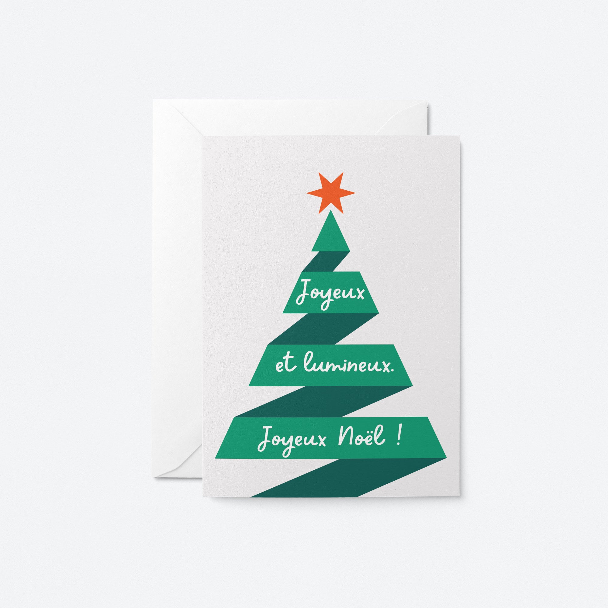 french christmas card with a christmas tree shaped green ribbon and a red star on top of it with a text that says Joyeux et lumineux