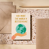 greeting card with earth on the palm of a hand with a text that says you make the world a better place  Edit alt text